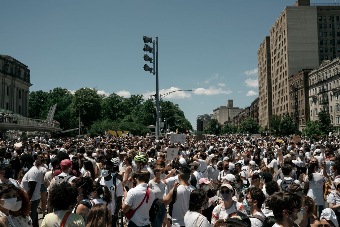 A large crowd of protesters dressed in white gather in Brooklyn to support the rights of transgender people of color.